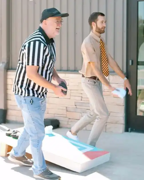 Team members playing cornhole